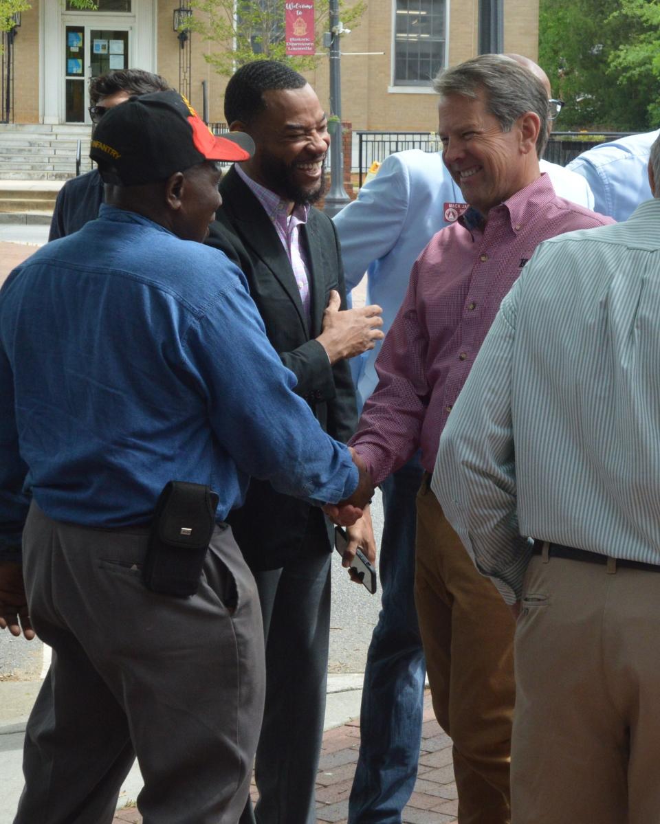 Gov. Kemp shakes hands and talks with constituents before giving a speech at a local restaurant.