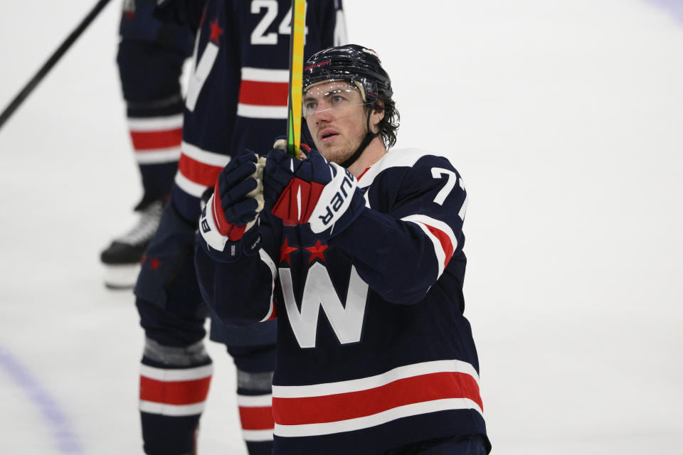 Washington Capitals right wing T.J. Oshie (77) salutes the fans after an NHL hockey game against the New York Islanders, Tuesday, April 26, 2022, in Washington. The Islanders 4-1. (AP Photo/Nick Wass)