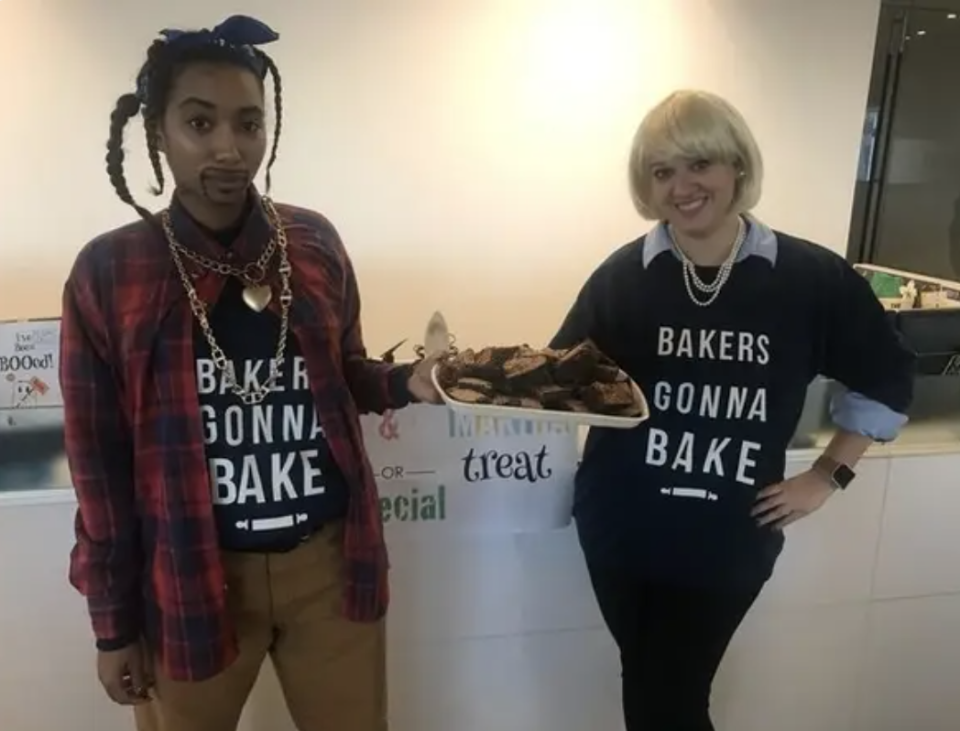 Two people dressed as Snoop Dogg and Martha Stewart, holding a tray of brownies, and wearing shirts that read "bakers gonna bake"