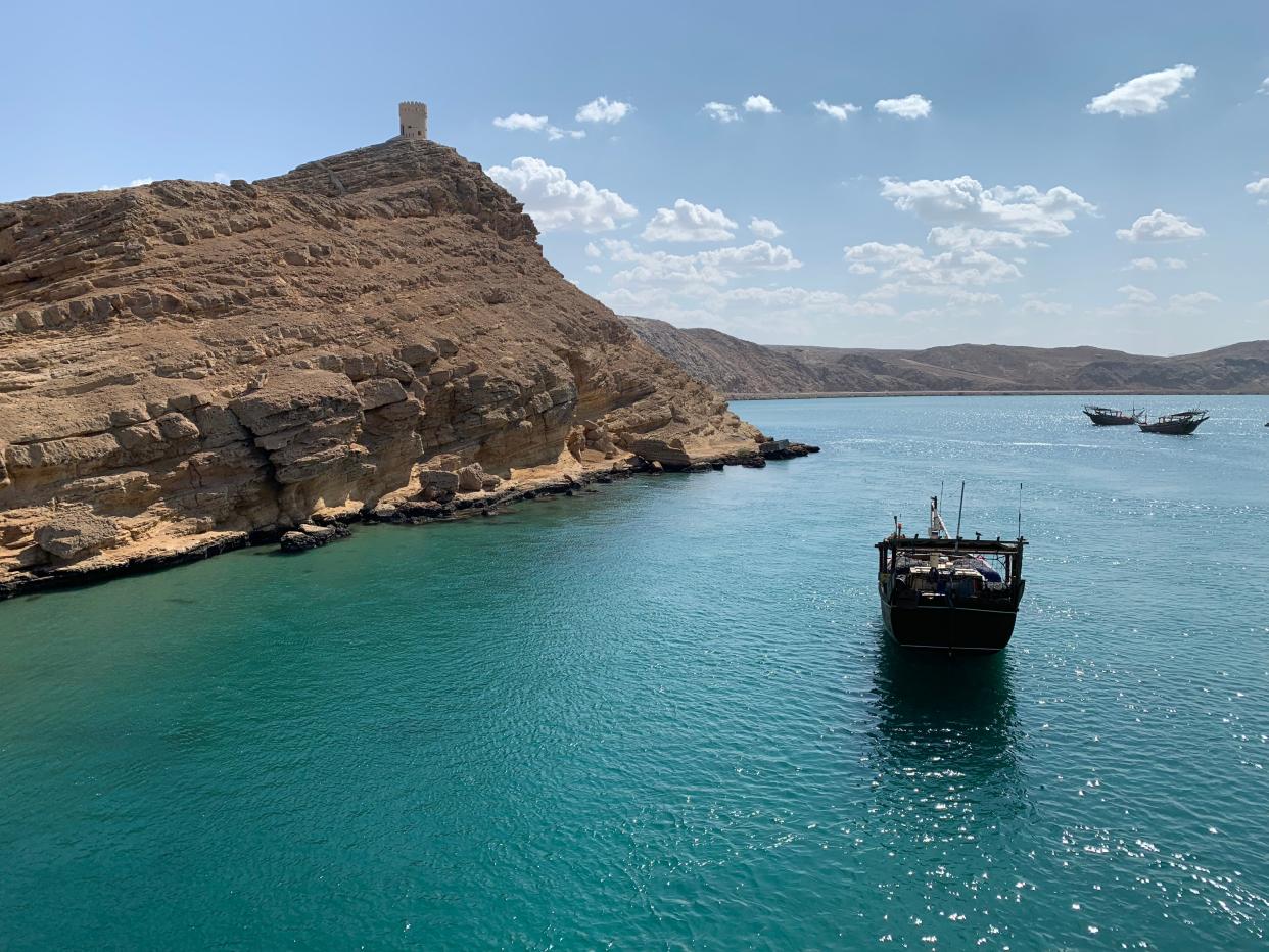 boats in the water off the shore of oman