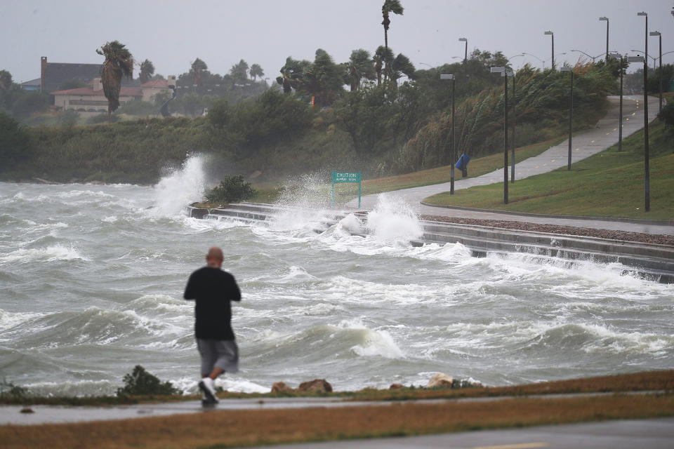 Sal Valerio walks near the bay waters as they churn from approaching Hurricane Harvey in Corpus Christi, Texas.&nbsp;