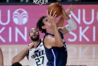 Dallas Mavericks' Boban Marjanovic shots as Utah Jazz's Rudy Gobert (27) defends during the first half of an NBA basketball game Monday, Aug. 10, 2020, in Lake Buena Vista, Fla. (AP Photo/Ashley Landis, Pool)