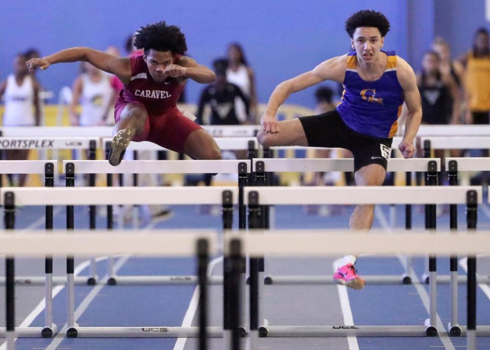 Caravel's Donovan Dixon (left) runs to a third place and Gabe Harris of Caesar Rodney is second in the 55 meter hurdles during the DIAA indoor track and field championships at the Prince George's Sports and Learning Complex in Landover, Md., Saturday, Feb. 3, 2024. Harris is the son of 800-meter state record holder Bruce Harris.