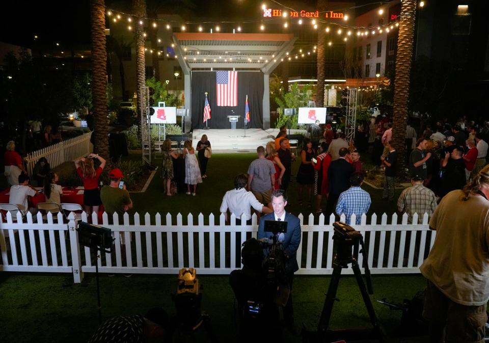 People watch the monitors as early votes roll in during a watch party for U.S. Senate candidate Blake Masters at the New Square in Chandler on Aug. 2, 2022.