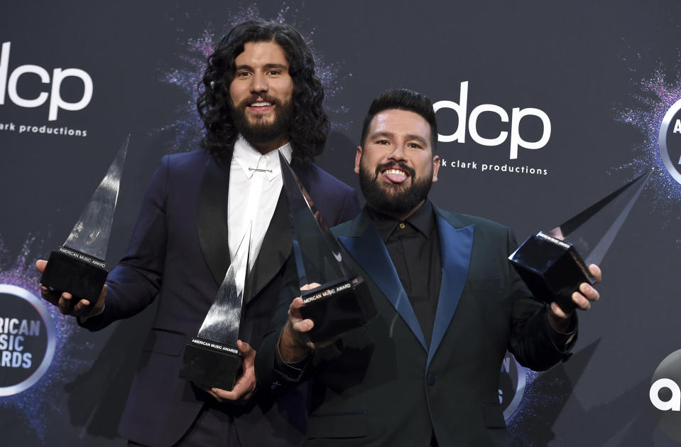 Dan Smyers, left, and Shay Mooney, of Dan + Shay, pose in the press room with the award for favorite country song for "Speechless" at the American Music Awards on Sunday, Nov. 24, 2019, at the Microsoft Theater in Los Angeles. (Photo by Jordan Strauss/Invision/AP)