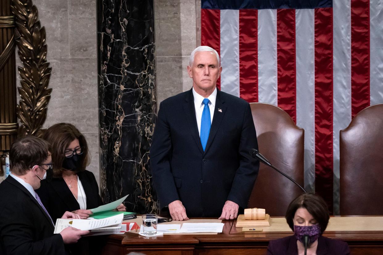 Vice President Mike Pence returns to the House chamber after midnight, Jan. 7, 2021, to finish the work of the Electoral College after a mob loyal to President Donald Trump stormed the Capitol in Washington and disrupted the process. 