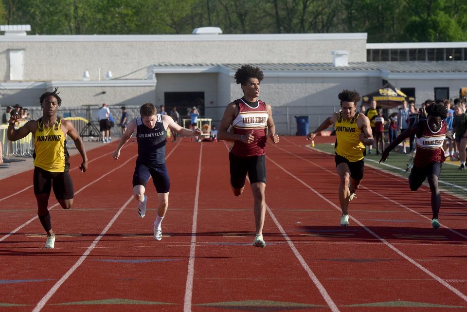 D.J. Fillmore of Licking Heights (center) edges out Watkins Memorial's Jaleel Sales (left) and Granville's Nate Newsom (second from left) in the LCL-Buckeye Division 100 meters Friday at Ascena Field.