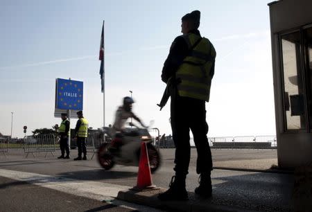 An armed French gendrame officer stands guard at the Franco-Italian border in Menton, France, January 24, 2016. REUTERS/Eric Gaillard