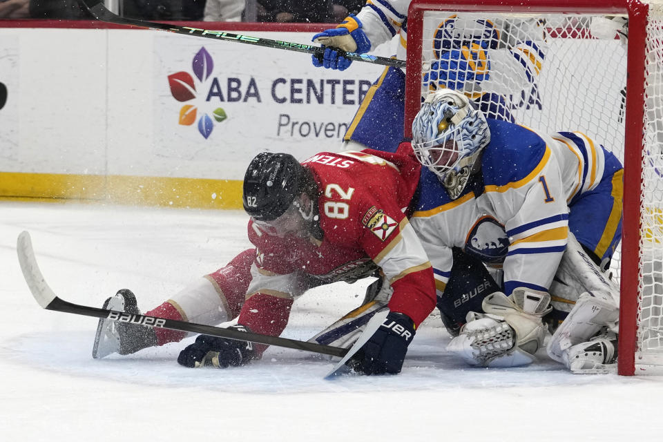 Florida Panthers center Kevin Stenlund (82) collides with Buffalo Sabres goaltender Ukko-Pekka Luukkonen (1) during the first period of an NHL hockey game, Saturday, April 13, 2024, in Sunrise, Fla. (AP Photo/Lynne Sladky)