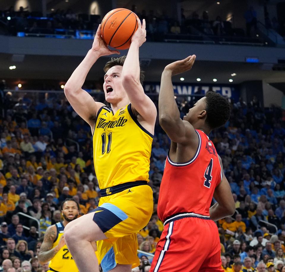 Marquette guard Tyler Kolek (11) drives up the court in attempt to score as he is guarded by St. John's guard Nahiem Alleyne (4) during the first half of their game on Saturday February 10, 2024 at Fiserv Forum in Milwaukee, Wis.