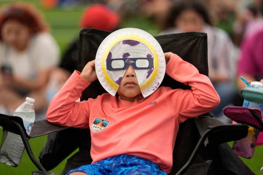 Yurem Rodriquez watches as the moon partially covers the sun during a total solar eclipse, as seen from Eagle Pass, Texas, Monday, April 8, 2024. (AP Photo/Eric Gay)