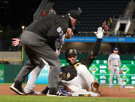 Jun 5, 2018; Pittsburgh, PA, USA; Pittsburgh Pirates pinch hitter Adam Frazier (26) is tagged out at third base attempting to advance on a fly-out as Los Angeles Dodgers third baseman Max Muncy (13) applies the tag to end the eighth inning at PNC Park. Mandatory Credit: Charles LeClaire-USA TODAY Sports