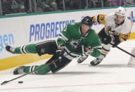 Dallas Stars defenseman John Klingberg (3) chases the puck against Pittsburgh Penguins center Teddy Blueger (53) during the second period of an NHL hockey game in Dallas, Saturday, Jan. 8, 2022. (AP Photo/LM Otero)