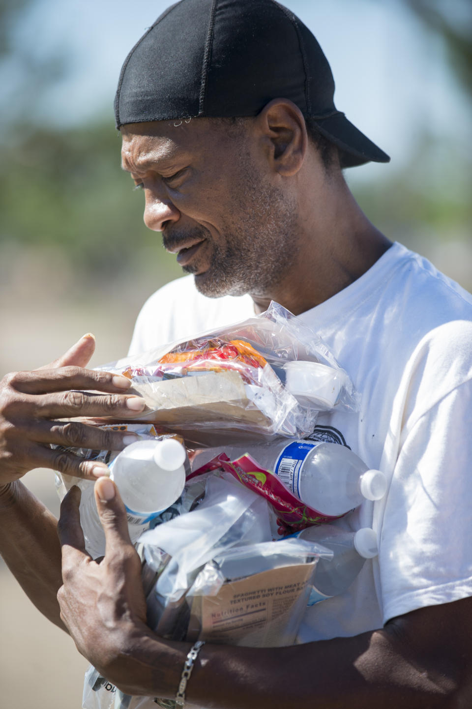 A resident of Lake Charles, La., carries supplies just given to him by members of the Salvation Army the morning after Hurricane Delta on Saturday, Oct. 10, 2020. (Chris Granger/The Advocate via AP)