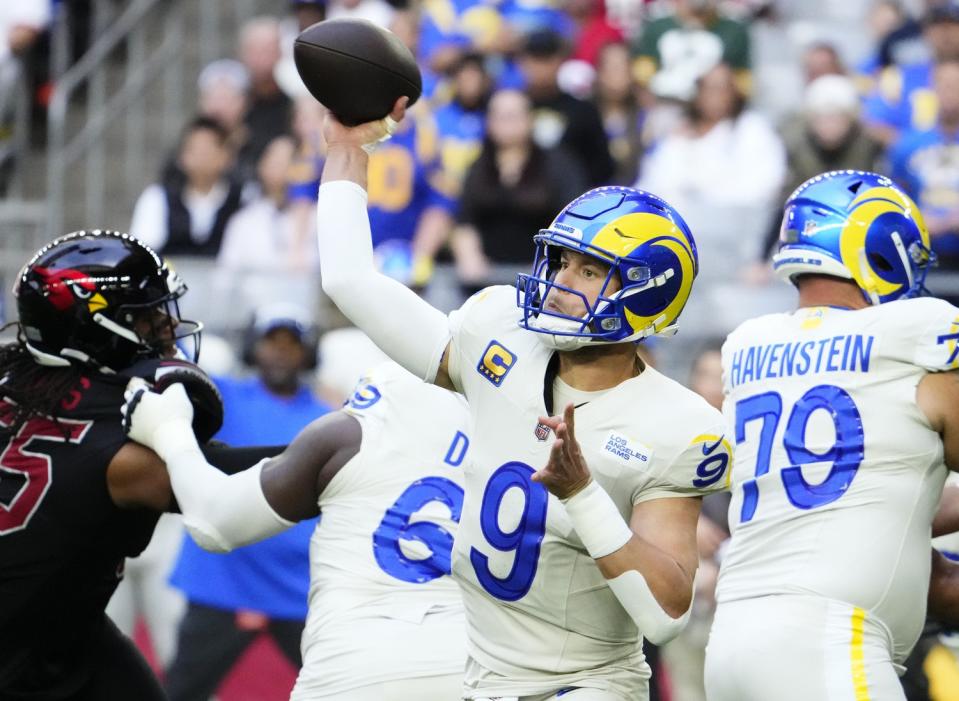 Los Angeles Rams quarterback <a class="link " href="https://sports.yahoo.com/nfl/players/9265" data-i13n="sec:content-canvas;subsec:anchor_text;elm:context_link" data-ylk="slk:Matthew Stafford;sec:content-canvas;subsec:anchor_text;elm:context_link;itc:0">Matthew Stafford</a> (9) throws a pass against the Arizona Cardinals in the first half at State Farm Stadium in Glendale on Nov. 26, 2023.