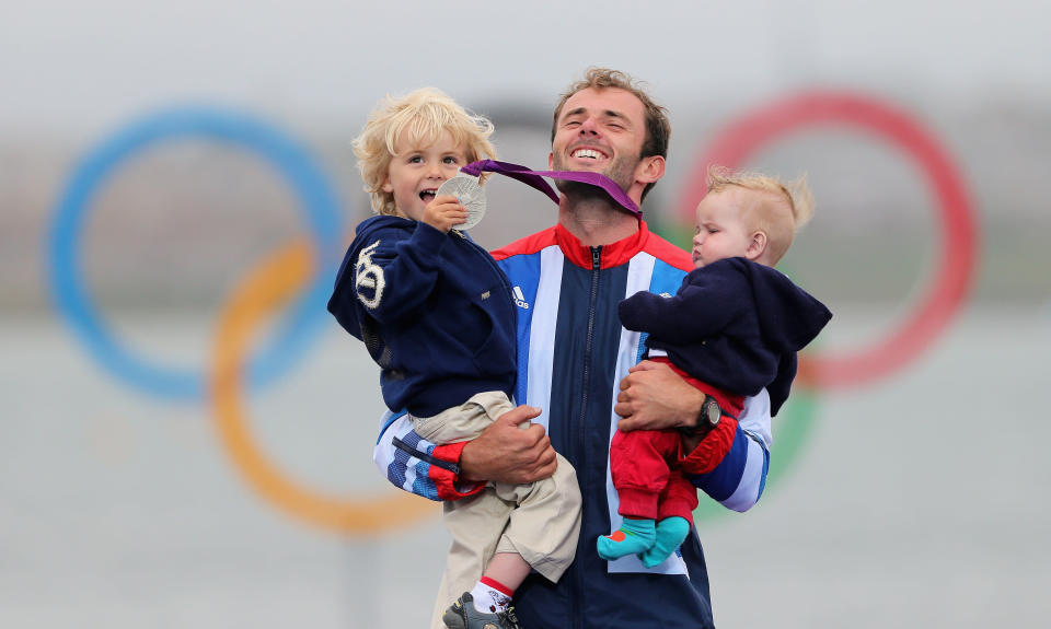 WEYMOUTH, ENGLAND - AUGUST 07: Silver medallist Nick Dempsey of Great Britain celebrates his children Thomas-Flynn (L) and Oscar (R) following the Men's RS:X Sailing on Day 11 of the London 2012 Olympic Games at the Weymouth & Portland Venue at Weymouth Harbour on August 7, 2012 in Weymouth, England. (Photo by Clive Mason/Getty Images)