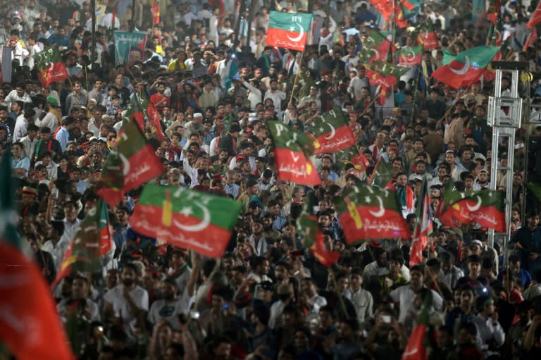 Supporters of opposition leader Imran Khan's Pakistan Tehreek-i-Insaf wave their party flags during a rally in Islamabad on July 30, 2017