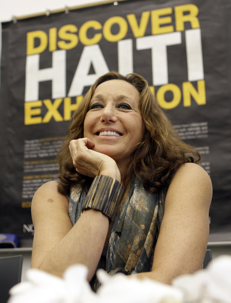 Fashion designer Donna Karan smiles as she talks to guests and visitors at the Little Haiti Cultural Center in Miami, Friday, May 17, 2013. Karan is among the designers and celebrities who have advocated for Haitian artisans since a catastrophic earthquake shook the Caribbean country in 2010. (AP Photo/Alan Diaz)