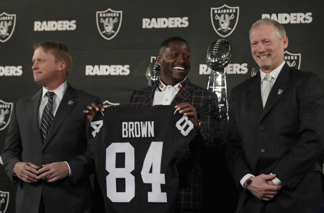 Oakland Raiders wide receiver Antonio Brown, center, holds his jersey beside coach Jon Gruden, left, and general manager Mike Mayock back in March. (AP)