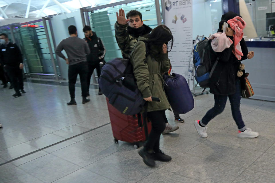Iraqi migrants arrive to the airport in Irbil, Iraq, early Friday, Nov. 26, 2021. 170 Iraqi nationals returned home Friday from Belarus in a repatriation process that came after tensions at Poland's eastern border, where thousands of migrants became stuck in a cold and soggy forest. (AP Photo/Hussein Ibrahim)