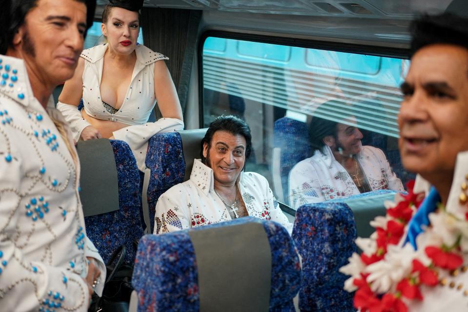 Elvis Presley impersonator Ross Mancini chats with fellow enthusiasts while boarding a train at Sydney Central Railway Station before departing for the Parkes Elvis Festival, as the event returns following the coronavirus disease (COVID-19) pandemic, in Sydney, Australia, April 21, 2022. REUTERS/Loren Elliott