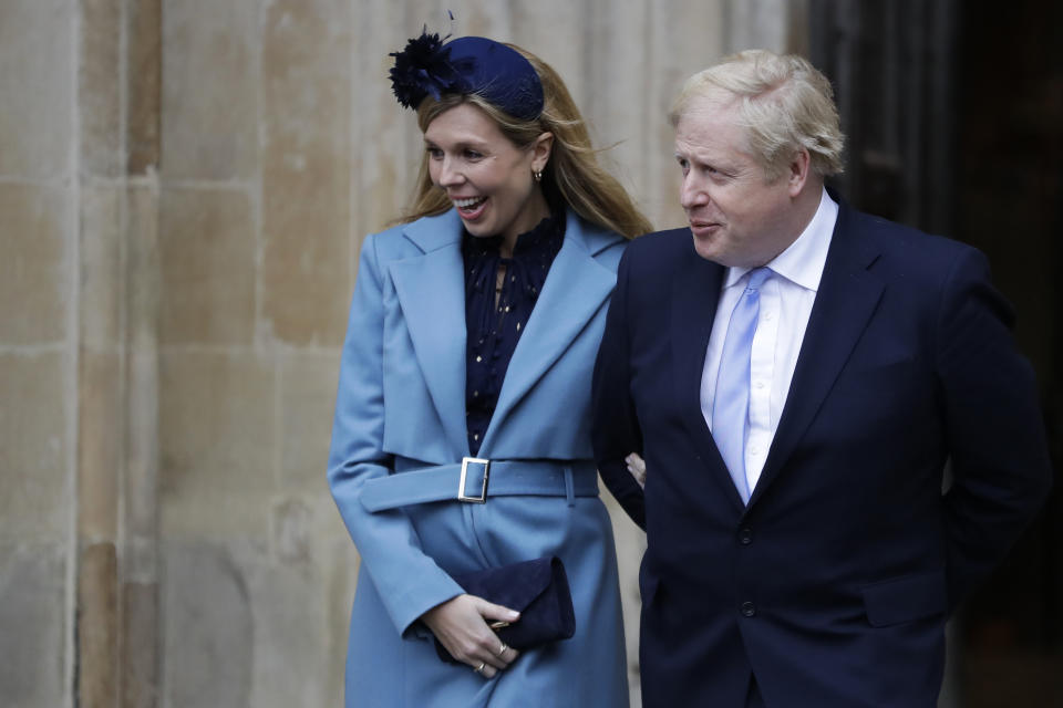 Britain's Prime Minister Boris Johnson and his partner Carrie Symonds leave after attending the annual Commonwealth Day service at Westminster Abbey in London, Monday, March 9, 2020. The annual service, organised by the Royal Commonwealth Society, is the largest annual inter-faith gathering in the United Kingdom. (AP Photo/Kirsty Wigglesworth)