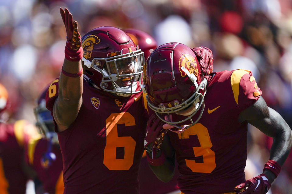 Southern California running back Austin Jones (6) celebrates with wide receiver Jordan Addison (3) after scoring during the first half of an NCAA college football game against Rice in Los Angeles, Saturday, Sept. 3, 2022. (AP Photo/Ashley Landis)