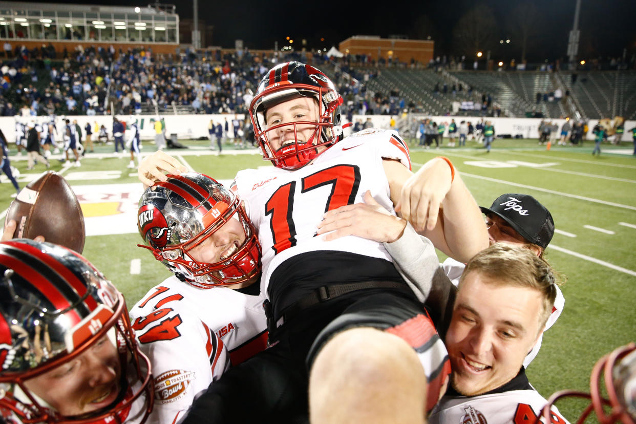 Teammates celebrate with kicker Lucas Carneiro after his game-winning field goal. (Isaiah Vazquez/Getty Images)