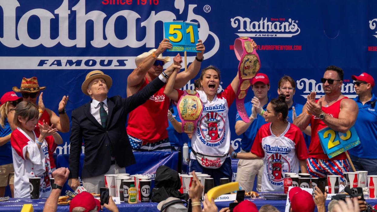 <div>NEW YORK, NEW YORK - JULY 4: Miki Sudo wins the women's title with a record-breaking 51 hot dogs at Nathan's Annual Hot Dog Eating Contest on July 4, 2024 in New York City. Sixteen-time winner Joey Chestnut is banned from this year's contest due to his partnership with Nathan's competitor Impossible Foods, which sells plant-based hot dogs. (Photo by Adam Gray/Getty Images)</div>