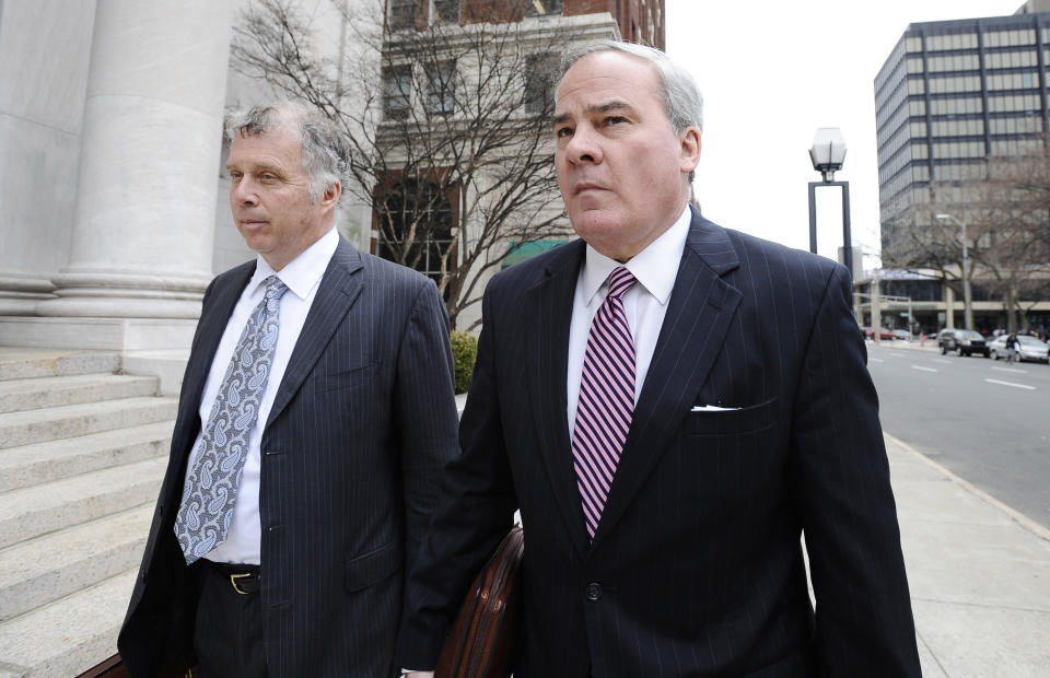 Former Connecticut Gov. John G. Rowland arrives with attorney Reid Weingarten at federal court, Friday, April 11, 2014, in New Haven, Conn. A grand jury on Thursday returned a seven-count indictment alleging Rowland schemed to conceal involvement with congressional campaigns. (AP Photo/Jessica Hill)