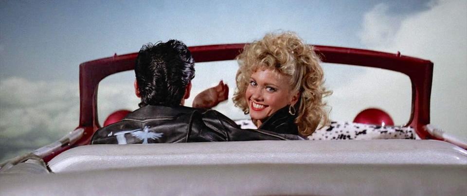 <p>The key to this theory is both at the beginning and end of the film: <em>Grease</em> opens with Sandy and Danny meeting at the beach, and <a href="https://www.youtube.com/watch?v=oI9LZDWyuBQ" rel="nofollow noopener" target="_blank" data-ylk="slk:ends with a final shot;elm:context_link;itc:0;sec:content-canvas" class="link ">ends with a final shot</a> of the couple driving up towards the skies in a flying car. </p><p>Well, <a href="https://www.goodhousekeeping.com/life/entertainment/news/a40321/grease-fan-theory-sandy-danny-dead/" rel="nofollow noopener" target="_blank" data-ylk="slk:one dark fan theory;elm:context_link;itc:0;sec:content-canvas" class="link ">one dark fan theory</a> posits that Sandy actually drowned at the beach (remember when Danny sings, "I saved her life; she nearly drowned" in "Summer Nights"?) and the entire movie is just a fantasy sequence playing in Sandy's head as she dies, with the last scene in the car signifying Sandy being sent up to heaven. Talk about the lyric "I've got chills, they're multiplying!" <br></p>