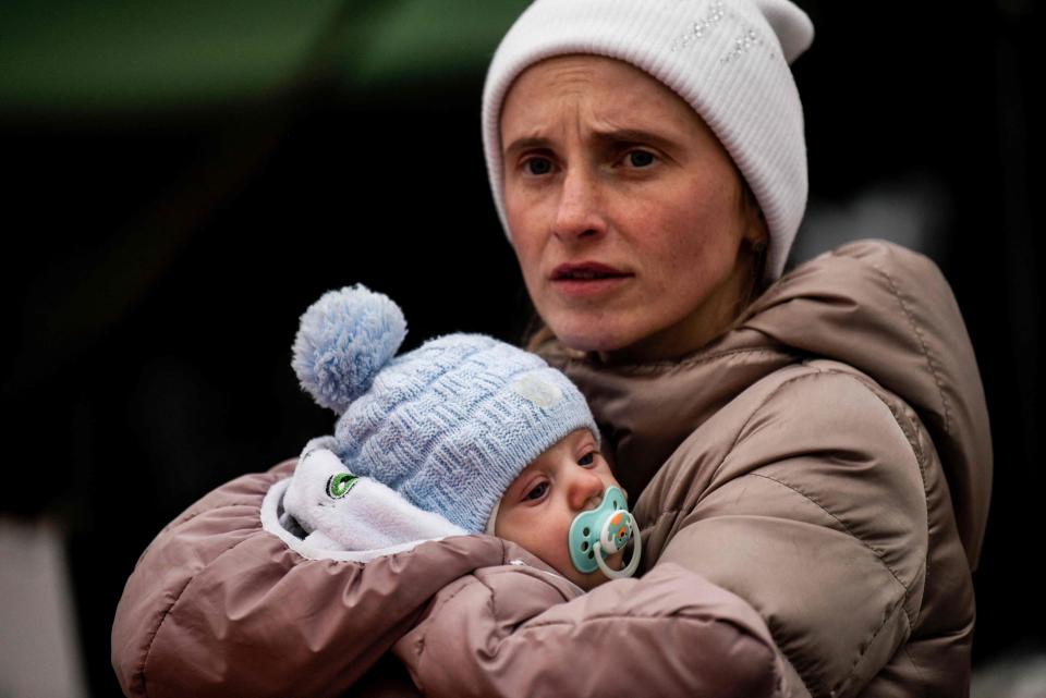 Ukrainian evacuee Luda Oksonenko holds her two month old baby after crossing the Ukrainian-Romanian border in Siret, northern Romania, on March 16, 2022. -