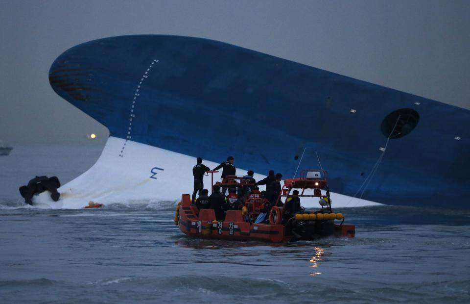 Maritime police search for missing passengers near capsized South Korean ferry "Sewol" at the sea off Jindo