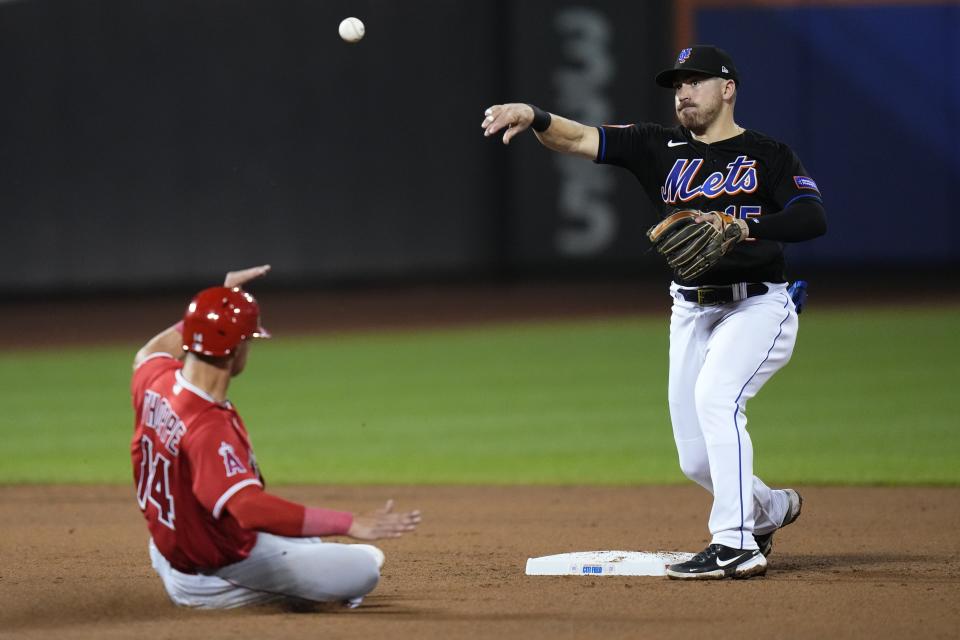 New York Mets' Danny Mendick, right, throws out Los Angeles Angels' Hunter Renfroe at first base after forcing out Los Angeles Angels' Logan O'Hoppe, left, for a double play during the sixth inning of a baseball game, Friday, Aug. 25, 2023, in New York. (AP Photo/Frank Franklin II)