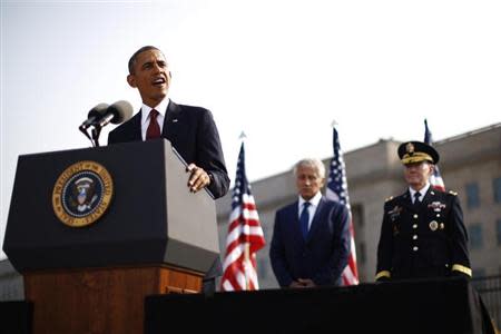 U.S. President Barack Obama speaks alongside Secretary of Defense Chuck Hagel (C) and Chairman of the Joint Chiefs of Staff Martin Dempsey (R) as they participate in an event on the 12th anniversary of the 9/11 attacks at the Pentagon near Washington, September 11, 2013. (REUTERS/Jason Reed)