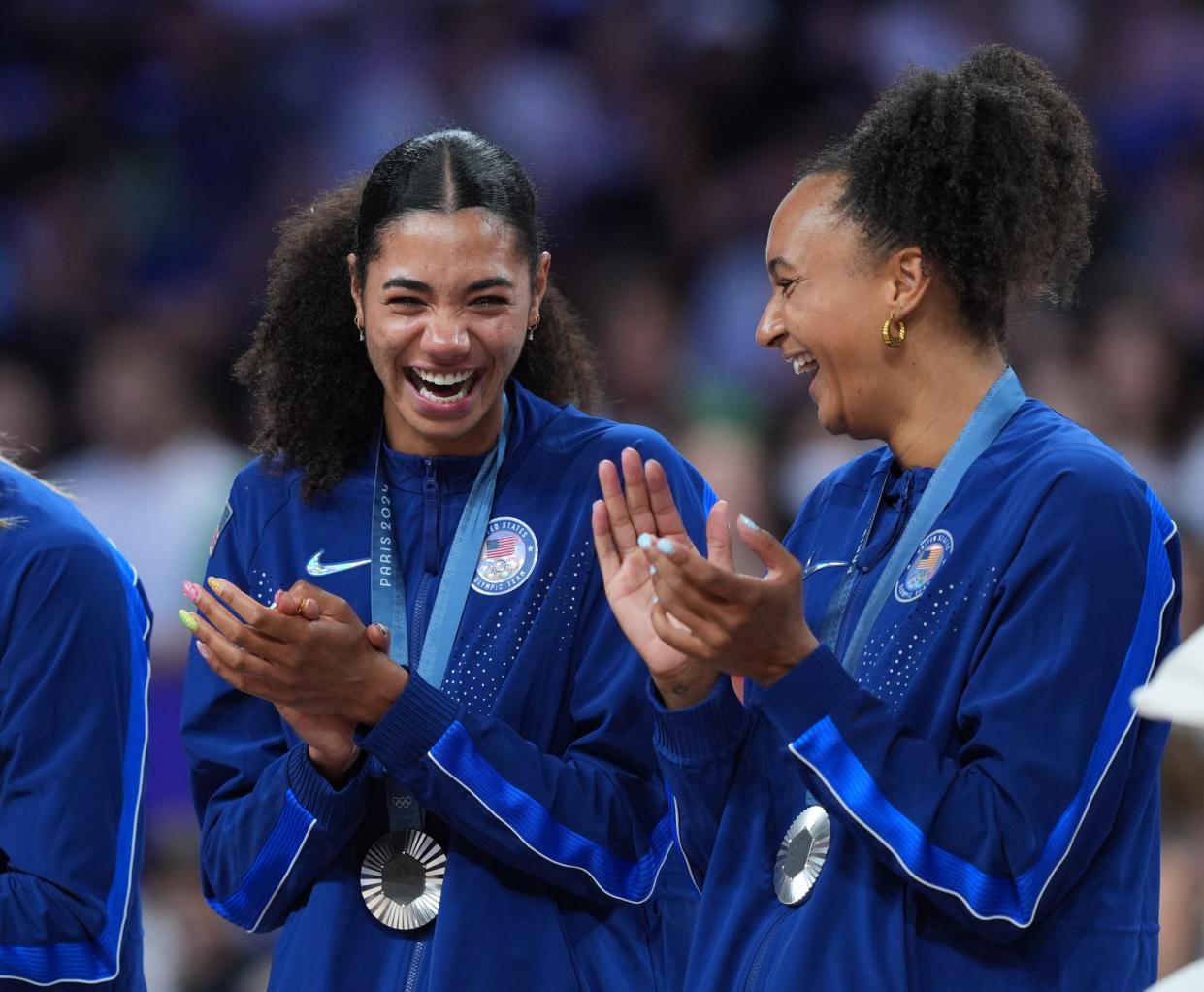 Aug 11, 2024; Paris, France; United States opposite Jordan Thompson (12) and United States middle blocker Haleigh Washington (15) receive their silver medals after the women's volleyball gold medal match during the Paris 2024 Olympic Summer Games at South Paris Arena.