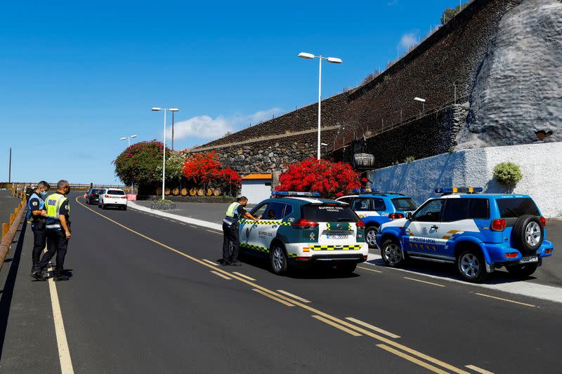 Police and civil guard members stand by as authorities on the Spanish Canary Island of La Palma are on alert for volcanic eruption, in La Palma