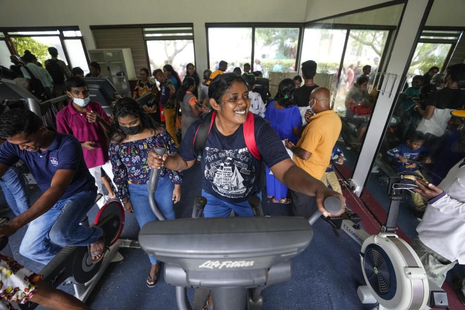 People use gym equipment as they take over President Gotabaya Rajapaksa's official residence on the second day after it was stormed in Colombo, Sri Lanka, July 11, 2022. The image was part of a series of images by Associated Press photographers that was a finalist for the 2023 Pulitzer Prize for Breaking News Photography. (AP Photo/Eranga Jayawardena)