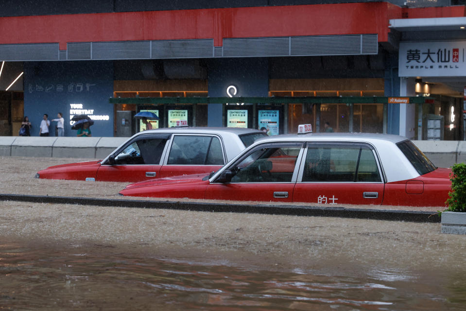 Cars partially submerged in floodwater in Hong Kong.