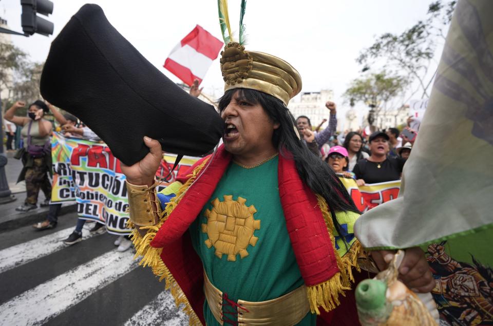A supporter of ousted President Pedro Castillo marches at the Plaza San Martin in Lima, Peru, Thursday, Dec. 8, 2022. Peru's Congress voted to remove Castillo from office Wednesday and replace him with the vice president, shortly after Castillo tried to dissolve the legislature ahead of a scheduled vote to remove him. (AP Photo/Fernando Vergara)