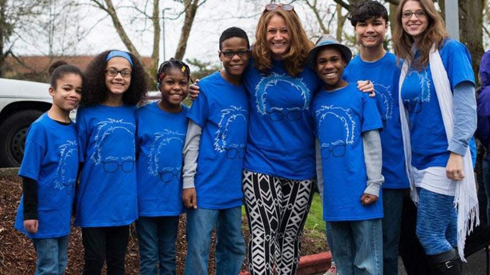 Jennifer and Sarah Hart (middle and far right) with their adopted children.