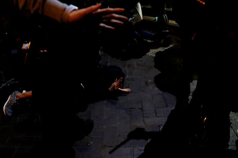 Riot police officers detain an anti-government protester during a demonstration on New Year's Eve outside Mong Kok police station in Hong Kong