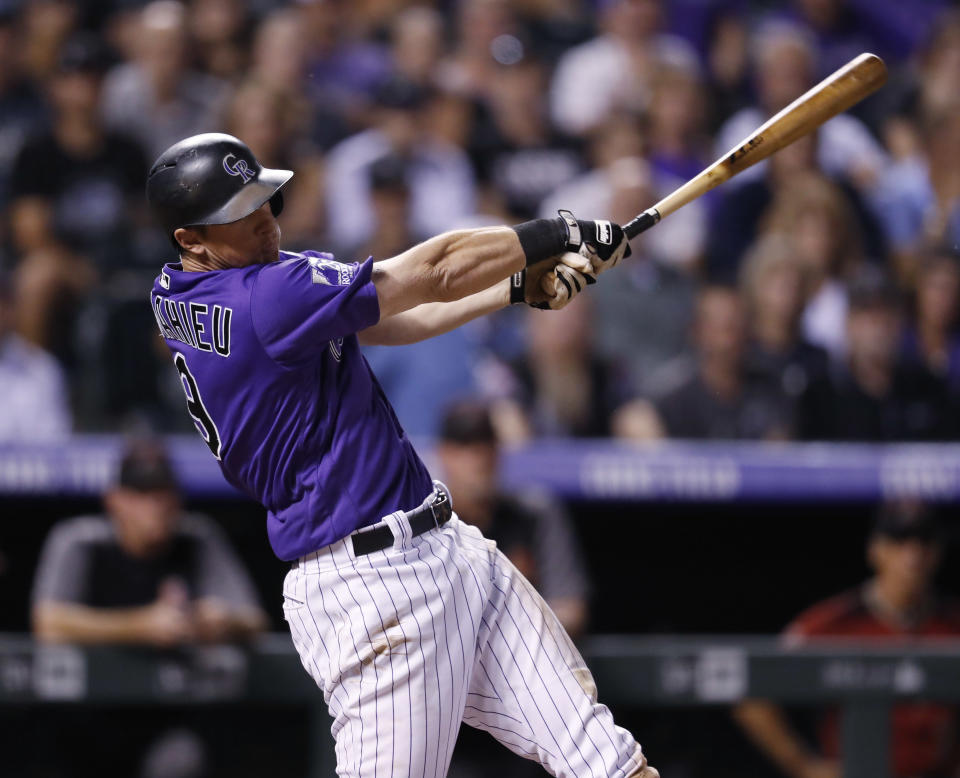 Colorado Rockies' DJ LeMahieu follows through with his swing after connecting for a two-run, walkoff home run off Arizona Diamondbacks relief pitcher Yoshihisa Hirano in the ninth inning of a baseball game Wednesday, Sept. 12, 2018, in Denver. The Rockies won 5-4. (AP Photo/David Zalubowski)