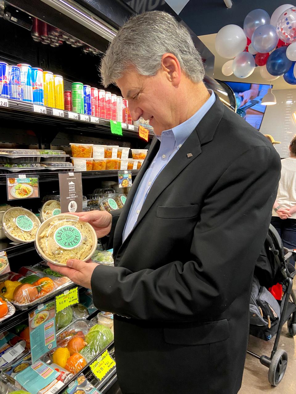 Tony Shinn, president of Bank of America-Oklahoma City, looks at a prepared meal during the grand opening of the Bank of America Community Resource Room at The Market at Eastpoint & Eastside Eatery, 1708 NE 23.