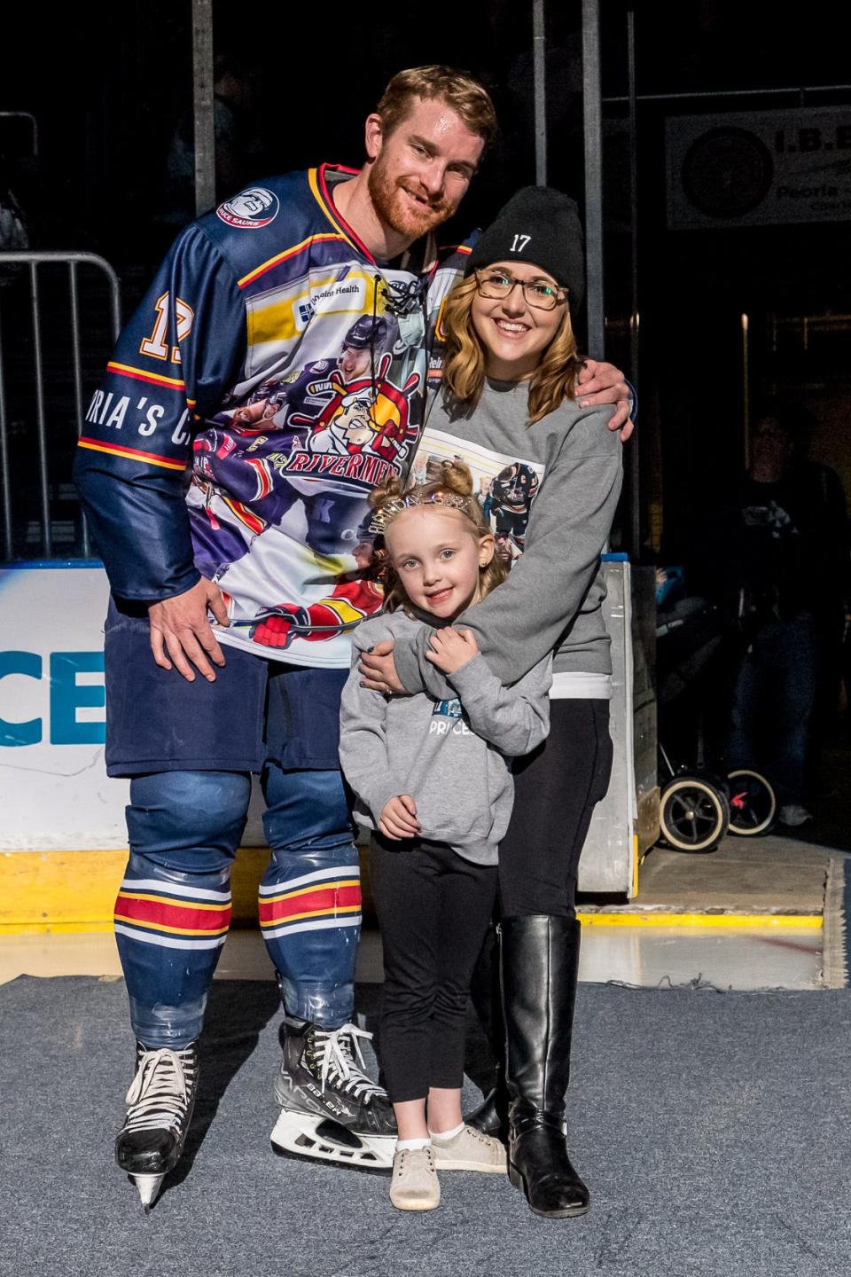 Peoria Rivermen captain Alec Hagaman and his wife, Emily, and daughter, Adley after a pre-game ceremony in which the longtime Rivermen star announced he will retire after the 2022-23 playoffs.