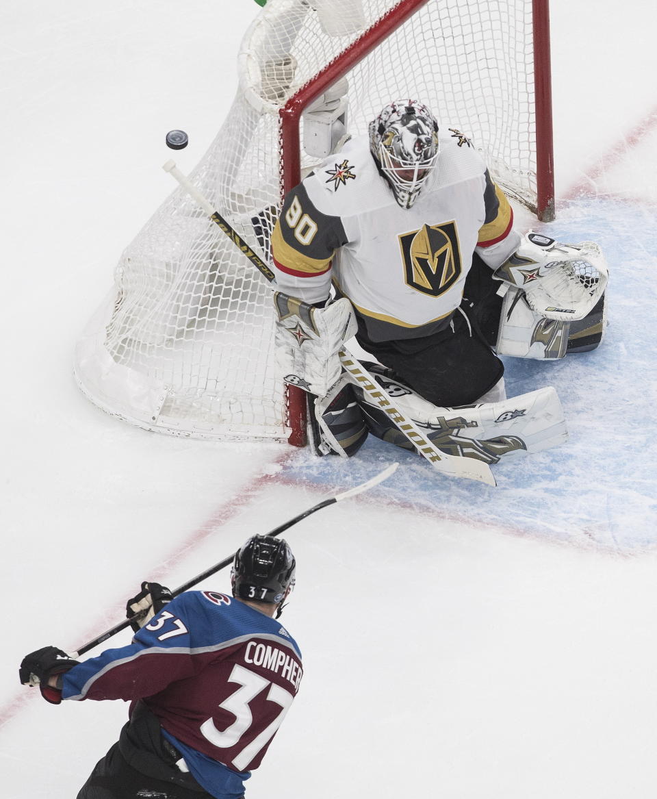 Colorado Avalanche's J.T. Compher (37) is stopped by Vegas Golden Knights goalie Robin Lehner (90) during the first period of an NHL Stanley Cup qualifying round game in Edmonton, Alberta, Saturday, Aug. 8, 2020. (Jason Franson/The Canadian Press via AP)