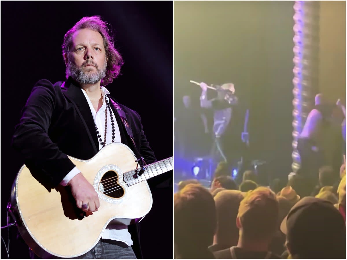 Robinson on stage earlier this year (left) and pushing the stage invader off with his guitar  (Getty/Greg Valentine/YouTube)