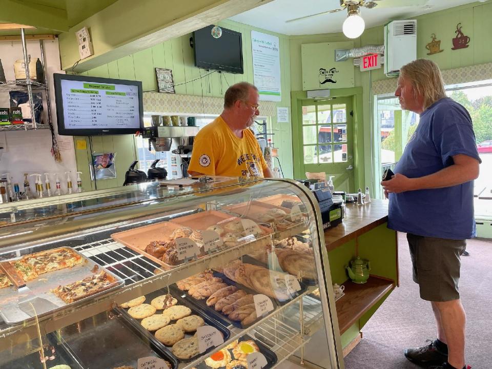 Brian Kennedy rings up a customer's order at Kurt Schulz Delicatessen and Pastry Shoppe in Brown Deer. Pastries and bakery are prepared in house daily, as are meats, pizzas, salads and soups.