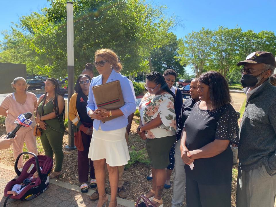 Margie Pizarro, surrounded by and attorney for the family of Tanglewood Middle School shooting victim Jamari Jackson, speaks outside the Greenville County Family Court on May 12, 2022.