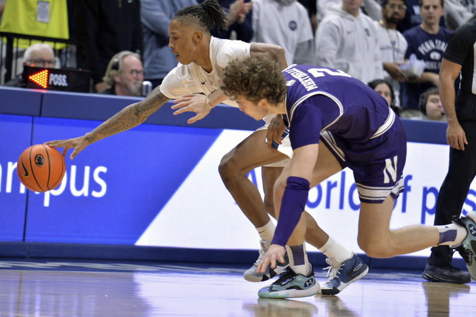 Penn State's Nick Kern Jr., left, steals the ball from Northwestern's Nick Martinelli (2) during the first half of an NCAA college basketball game Wednesday, Jan. 10, 2024, in State College, Pa. (AP Photo/Gary M. Baranec)